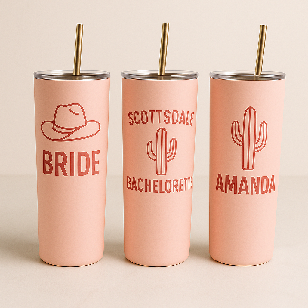 Three pink tumblers with personalized designs on a beige background